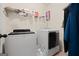 Laundry room features front loading washer and dryer with wire shelving at 2441 Noelle Ln, Powder Springs, GA 30127