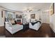 Cozy living room featuring a fireplace, hardwood floors, and comfortable seating at 2441 Noelle Ln, Powder Springs, GA 30127