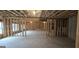Unfinished basement with stud framing, concrete floors and ceiling, and windows at 336 Traditions Ln # 147, Hampton, GA 30228