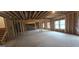 Spacious unfinished basement with exposed wood framing, concrete floor and natural light from windows at 336 Traditions Ln # 147, Hampton, GA 30228