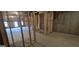 Unfinished basement with stud framing and windows, ready for customization at 336 Traditions Ln # 147, Hampton, GA 30228