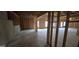 Vast unfinished basement with exposed framing and concrete flooring, ready for customization at 336 Traditions Ln # 147, Hampton, GA 30228