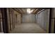 Spacious unfinished basement with concrete walls and ceiling with some stud framing at 336 Traditions Ln # 147, Hampton, GA 30228