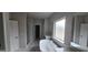 Bright bathroom featuring a soaking tub, shower, and double vanities at 336 Traditions Ln # 147, Hampton, GA 30228