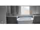 Elegant bathroom with a soaking tub, double vanity, and marble walk-in shower at 336 Traditions Ln # 147, Hampton, GA 30228