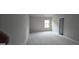 Empty bedroom features neutral carpet and paint, ready for personalization at 336 Traditions Ln # 147, Hampton, GA 30228