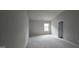 Empty bedroom features neutral carpet and paint, ready for personalization at 336 Traditions Ln # 147, Hampton, GA 30228