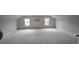 Large bonus room with neutral carpet and paint, ready for personalization at 336 Traditions Ln # 147, Hampton, GA 30228