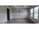 Bright dining room featuring wainscoting, modern chandelier and luxury vinyl plank flooring at 336 Traditions Ln # 147, Hampton, GA 30228