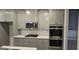 Modern kitchen features stainless steel appliances and shaker style cabinetry at 336 Traditions Ln # 147, Hampton, GA 30228