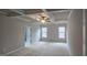 Spacious main bedroom featuring a tray ceiling, neutral carpet and ensuite bathroom access at 336 Traditions Ln # 147, Hampton, GA 30228