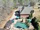 Aerial view of home featuring a pool, deck, manicured landscaping, and wooded backdrop at 312 Dogwood Trce, Mcdonough, GA 30252