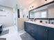 Bathroom featuring glass-enclosed shower, freestanding tub, dual vanity and ample counter space at 4436 Old Country Way, Snellville, GA 30039