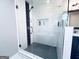Modern bathroom shower featuring white tiling, black accents, and sleek glass enclosure at 4436 Old Country Way, Snellville, GA 30039