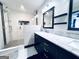 Modern bathroom features a glass-enclosed shower with dual shower heads and a sleek vanity with marble countertop at 4436 Old Country Way, Snellville, GA 30039