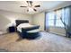 Comfortable bedroom features neutral carpet, ceiling fan and natural light from the large window at 4436 Old Country Way, Snellville, GA 30039
