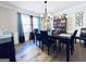 Formal dining room featuring hardwood floors, an elegant chandelier, and decorative accents that create a sophisticated ambiance at 4436 Old Country Way, Snellville, GA 30039