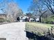 Inviting two-story home boasts a spacious driveway, attached two-car garage, and landscaped front yard, all set against a bright blue sky at 4436 Old Country Way, Snellville, GA 30039
