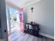 Inviting foyer with a red front door, wood-look floors, and decorative display cabinet at 4436 Old Country Way, Snellville, GA 30039