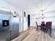 Bright kitchen with modern stainless steel refrigerator, stylish wine rack, and dining area, providing a blend of functionality and charm at 4436 Old Country Way, Snellville, GA 30039