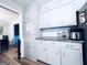 Bright kitchen features white cabinets, stainless steel appliances, granite countertops, and view to dining area providing a clean, modern look at 4436 Old Country Way, Snellville, GA 30039