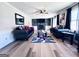 Cozy living room featuring hardwood floors, ample seating, and a decorative fireplace at 4436 Old Country Way, Snellville, GA 30039