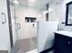 The glass-enclosed shower features dual shower heads, tiled walls, and a convenient built-in niche for storage at 4436 Old Country Way, Snellville, GA 30039