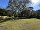 The backyard of the home shows expansive green space and mature trees under a blue sky at 3280 Gum Creek Rd, Oxford, GA 30054