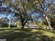 A large, grassy backyard with mature trees surrounds the rear of the property at 3280 Gum Creek Rd, Oxford, GA 30054
