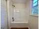 Updated bathtub with a white surround and natural light from the window at 3280 Gum Creek Rd, Oxford, GA 30054