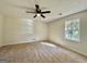 Bright bedroom with a ceiling fan and natural light from a window and neutral walls and carpet at 3280 Gum Creek Rd, Oxford, GA 30054