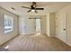 Spacious bedroom with carpet, ceiling fan, and barn door leading to a full bathroom at 3280 Gum Creek Rd, Oxford, GA 30054