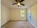 This cozy bedroom features neutral walls and carpet, a ceiling fan, and a window for natural light at 3280 Gum Creek Rd, Oxford, GA 30054