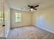 Bedroom with carpet and ceiling fan with a large window allowing lots of natural light at 3280 Gum Creek Rd, Oxford, GA 30054