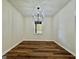 Bright dining room featuring hardwood floors, modern chandelier, and large window at 3280 Gum Creek Rd, Oxford, GA 30054