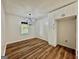 Bright dining room featuring hardwood floors, modern chandelier, and updated white cabinets at 3280 Gum Creek Rd, Oxford, GA 30054