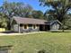 Charming single-story home featuring a metal roof, yellow shutters, and a well-manicured lawn at 3280 Gum Creek Rd, Oxford, GA 30054