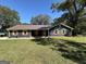 Inviting home features a spacious front yard and mature trees providing ample shade at 3280 Gum Creek Rd, Oxford, GA 30054