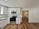 Well-lit kitchen with stainless appliances, granite countertops and wood flooring at 3280 Gum Creek Rd, Oxford, GA 30054