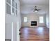 Bright living room featuring wood floors, a fireplace, and modern ceiling fan at 3280 Gum Creek Rd, Oxford, GA 30054