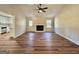 Spacious living room with wood floors, fireplace, and open layout to the kitchen at 3280 Gum Creek Rd, Oxford, GA 30054