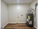 Utility room featuring luxury vinyl flooring and modern water heater at 3280 Gum Creek Rd, Oxford, GA 30054