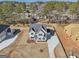 Aerial view of home in neighborhood with mature trees at 3725 Heron Creek Ct, Loganville, GA 30052