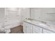 Bathroom with dual sinks, white cabinets, granite countertops, and walk-in shower at 3725 Heron Creek Ct, Loganville, GA 30052