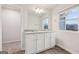 Bathroom with double vanity, granite countertop, and modern fixtures at 3725 Heron Creek Ct, Loganville, GA 30052