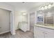 Bright bathroom features double vanity, wood-look floors, and walk-in shower at 3725 Heron Creek Ct, Loganville, GA 30052