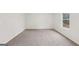 Bright bedroom features plush carpet and a window to let in natural light at 3725 Heron Creek Ct, Loganville, GA 30052