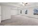 A spacious bedroom is brightly lit with multiple windows and a ceiling fan at 3725 Heron Creek Ct, Loganville, GA 30052