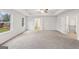 Spacious bedroom with tray ceiling, ceiling fan, plush carpet, and ensuite access at 3725 Heron Creek Ct, Loganville, GA 30052