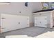 Spacious two-car garage plus a one car garage with white doors and black hardware at 3725 Heron Creek Ct, Loganville, GA 30052